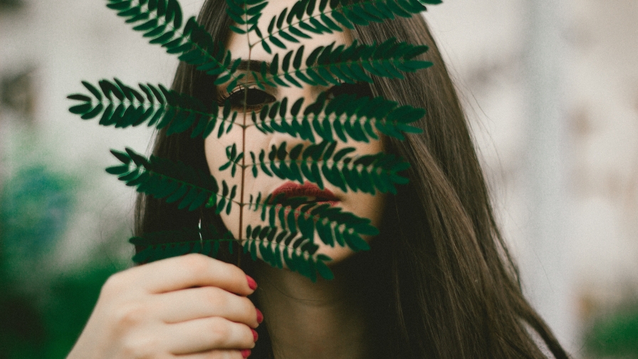 Beautiful Young Girl and Green Leaf