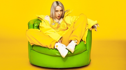 Billie Eilish Siting in Yellow Armchair