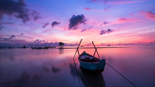 Boat on Lake and Purple Light of Sunset