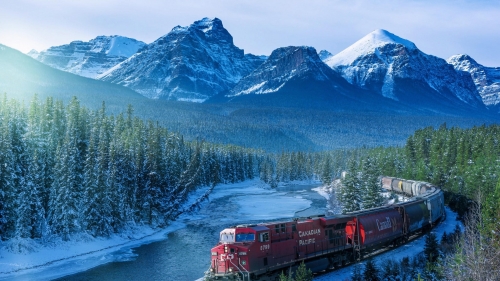 Red Train on Track and Winter Forest