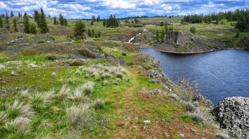 River in mountain valley and green grass