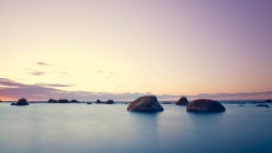 Sunset Purple Sky and Rocks in Water