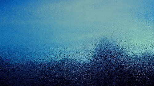 Water Drops on Glass and Blue Light