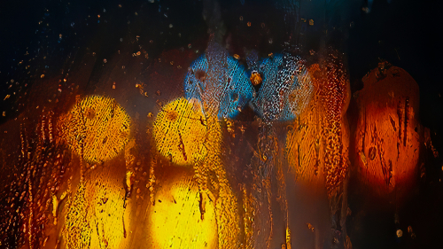 Water Drops on Glass with Orange and Blue Lights