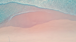 Waves and Beautiful Purple Sand on the Beach