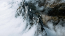 Wonderful Mountains Peaks in Clouds and Snow